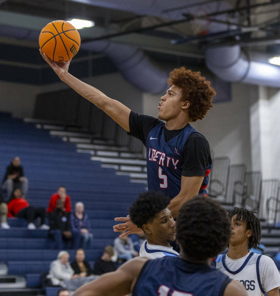 Liberty's Dante Steward (5) gets off a shot over Centennial's Bryce Iwuoha (44) during the seco ...