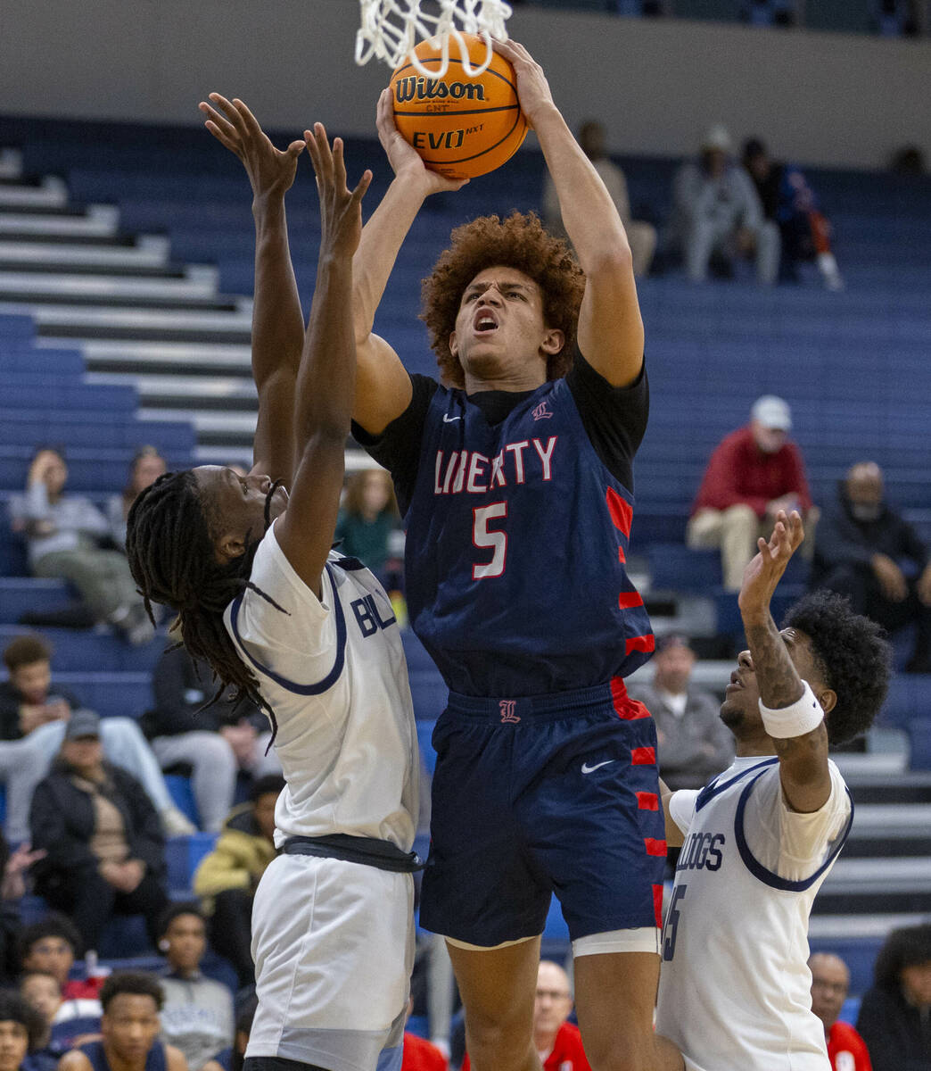 Liberty's Dante Steward (5) gets off a shot over Centennial's Jayden Ceaser (5) during the seco ...