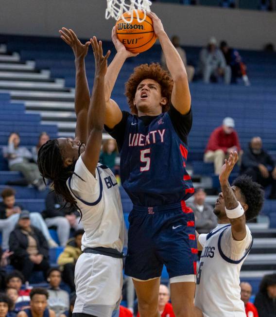 Liberty's Dante Steward (5) gets off a shot over Centennial's Jayden Ceaser (5) during the seco ...