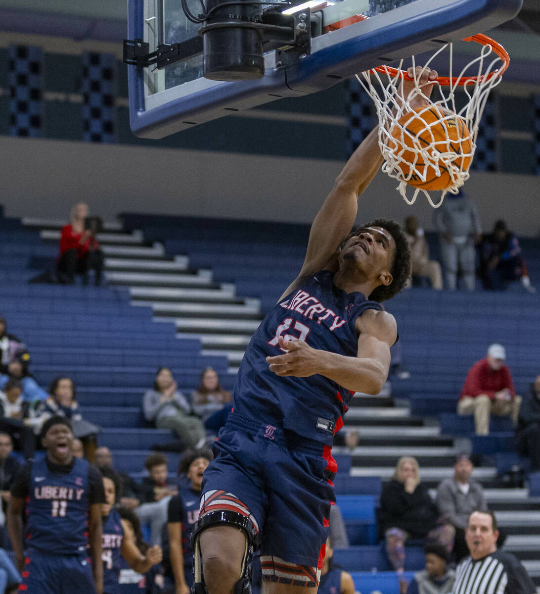 Liberty's Evan Hilliard (12) dunks the ball over Centennial during the second half of their NIA ...