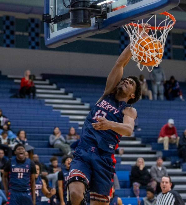 Liberty's Evan Hilliard (12) dunks the ball over Centennial during the second half of their NIA ...