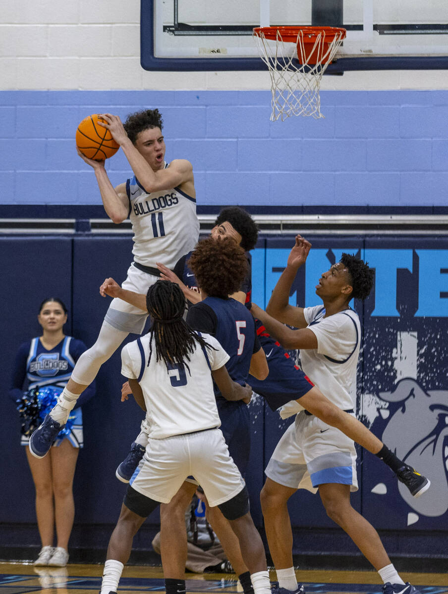 Centennial's Jaxon Price (11) secures a rebound over Liberty defenders during the second half o ...