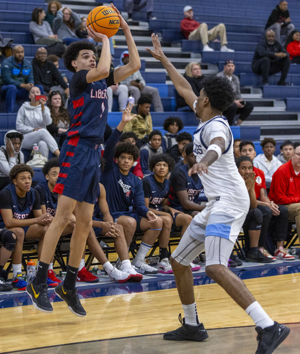 Liberty's Jalen Parker (1) gets off a shot over Centennial's Jaden Dudley (15) during the secon ...