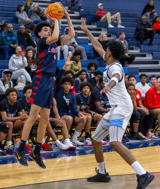 Liberty's Jalen Parker (1) gets off a shot over Centennial's Jaden Dudley (15) during the secon ...