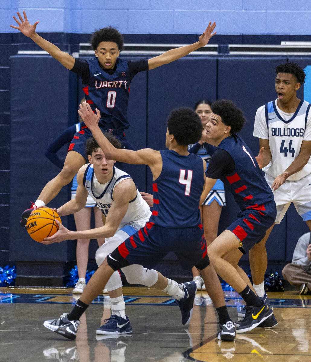 Centennial's Jaxon Price (11) looks to pass over Liberty defenders including Taytum Cios-Webb ( ...