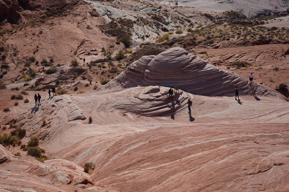 Valley of Fire State Park visitors chat and take pictures at the Fire Wave. (Natalie Burt)