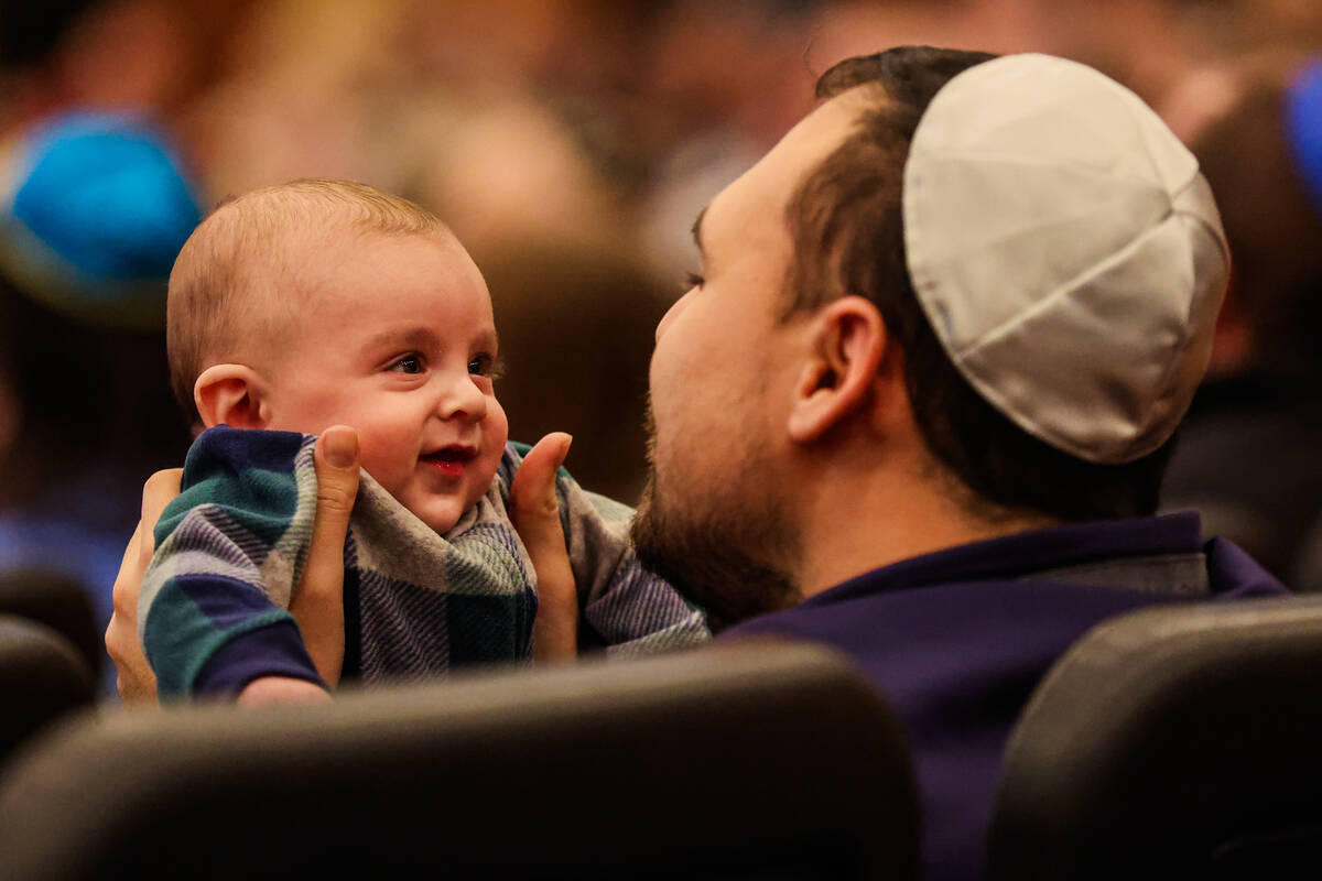 A baby smiles during a Beatles themed Shabbat service at Congregation Ner Tamid on Friday, Jan. ...