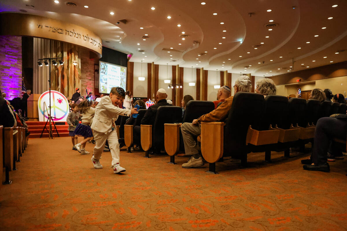 Children run around during a Beatles themed Shabbat service at Congregation Ner Tamid on Friday ...