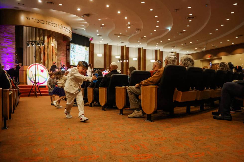 Children run around during a Beatles themed Shabbat service at Congregation Ner Tamid on Friday ...