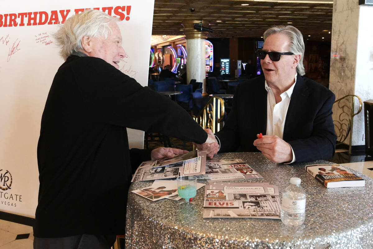 Kent Lichfield shakes hands with Elvis Presley’s stepbrother David Stanley during a kick ...