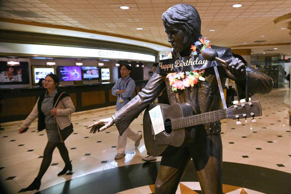 A statue of Elvis Presley in the lobby of the Westgate is decorated for his birthday during a k ...