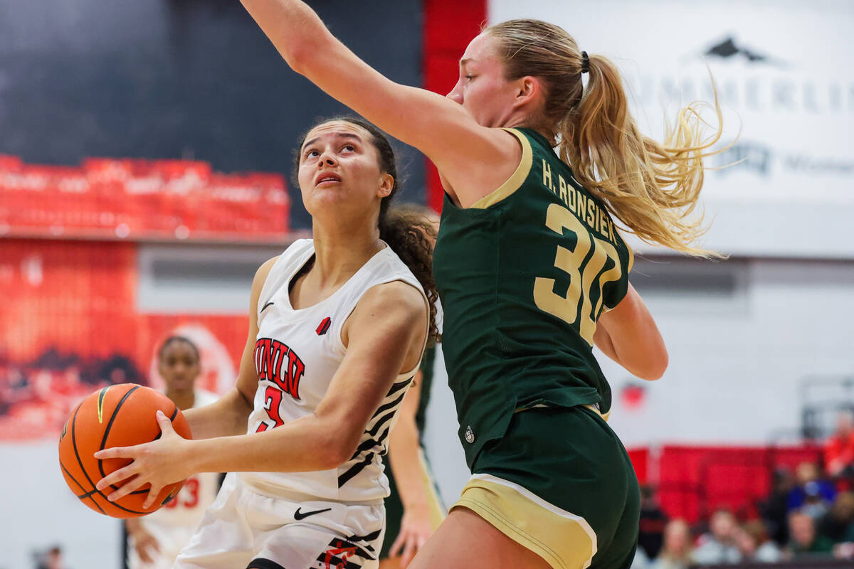 Lady Rebels guard Kiara Jackson (3) drives to the basket while Colorado State Rams guard Hannah ...