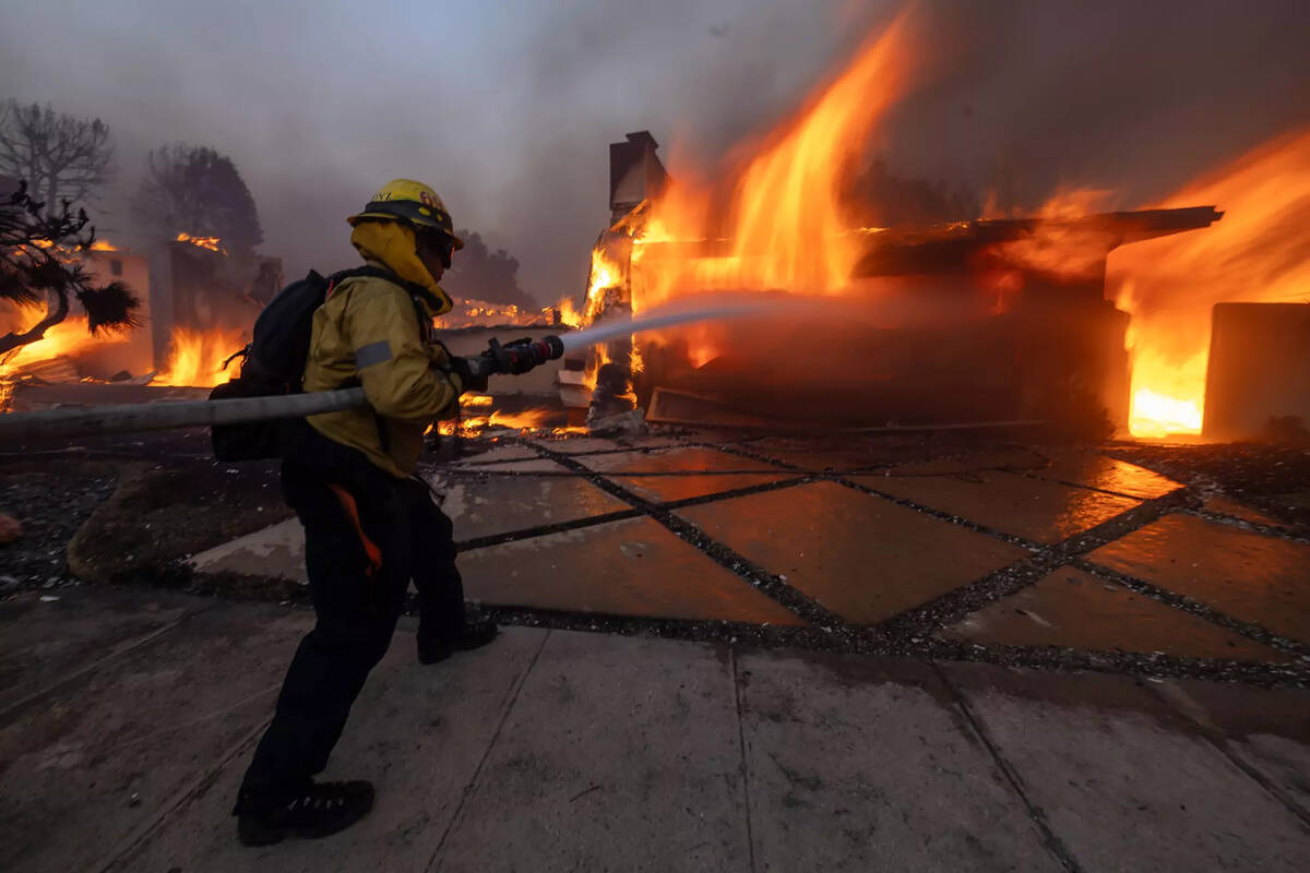 Firefighters battle the Palisades fire on El Medio Ave. in Pacific Palisades, Jan 7, 2025.. (Br ...