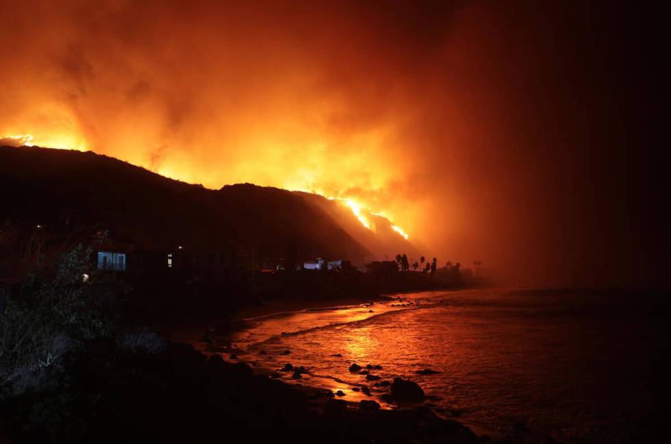 The Palisades Fire burns along Pacific Coast Highway in Malibu, California, on Tuesday, Jan 7, ...