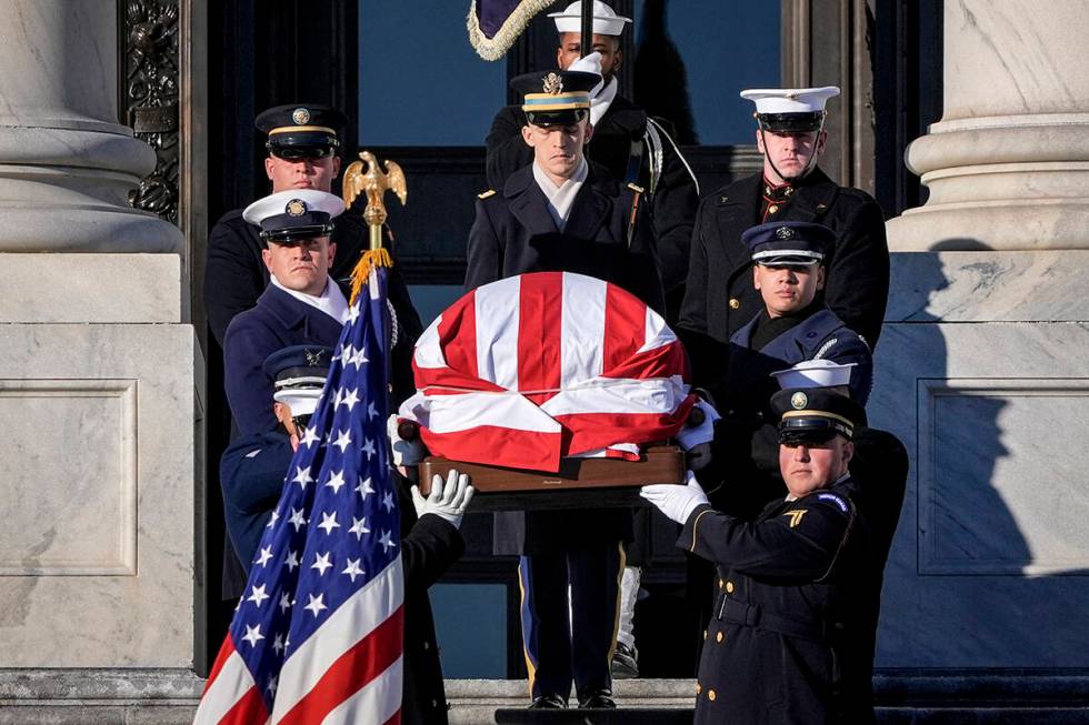 The flag-draped casket of former President Jimmy Carter is carried from the U.S. Capitol on the ...