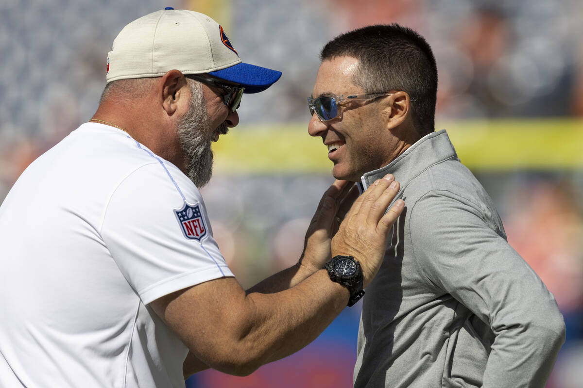 Raiders general manager Tom Telesco, right, meets with Denver Broncos inside linebackers coach ...