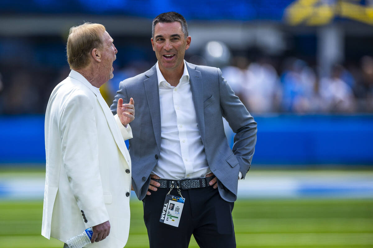 Raiders owner Mark Davis talks with general manage Tom Telesco on the sidelines before the firs ...