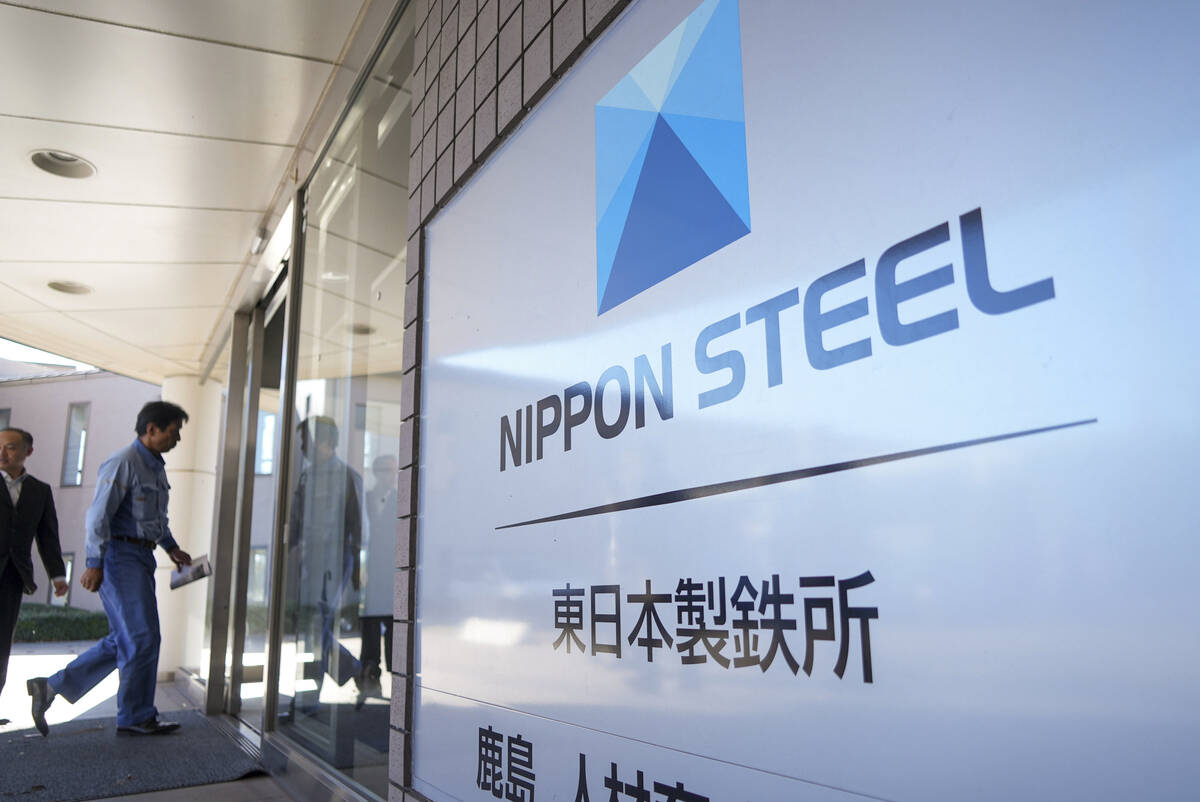 FILE - A staff enters doorway next to Nippon Steel logo at the company's Kashima Plant in Kashi ...