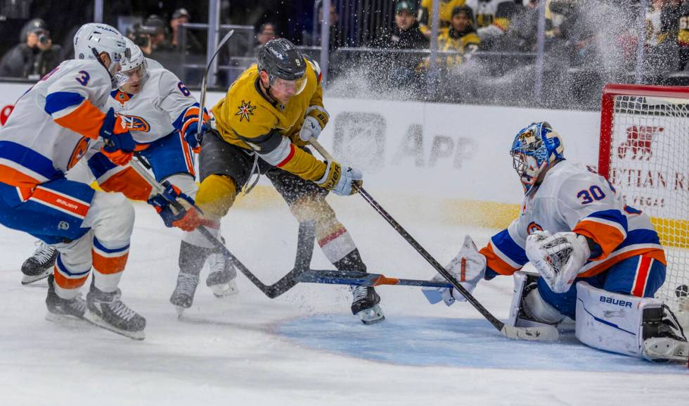 Golden Knights center Jack Eichel (9) takes a shot on goal against New York Islanders goaltende ...