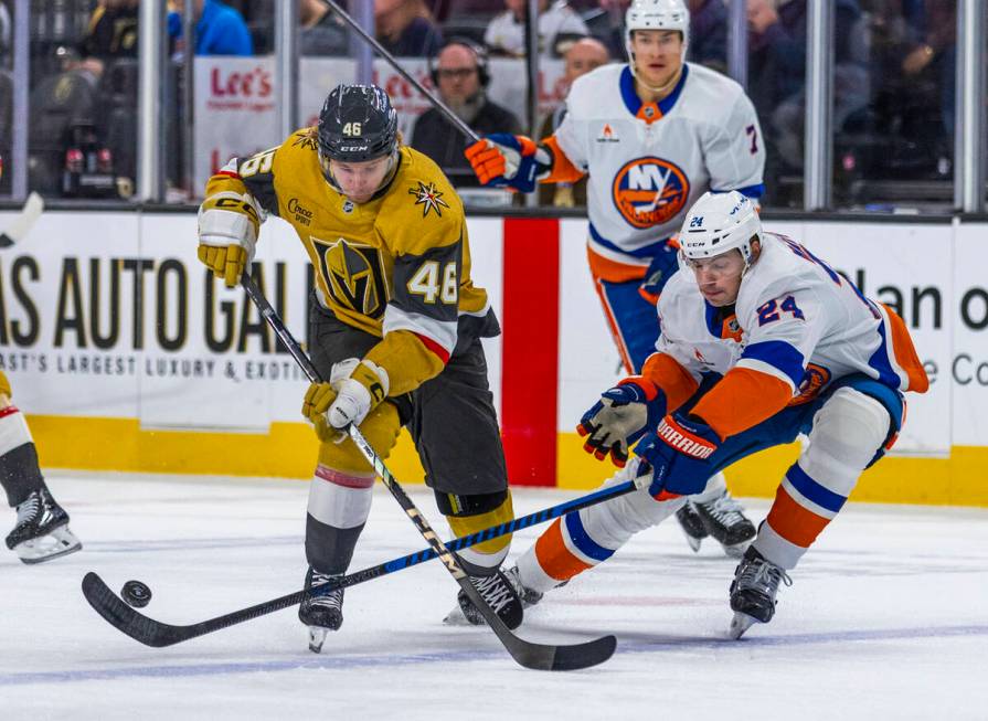 Golden Knights right wing Jonas Rondbjerg (46) has the puck taken away on a drive by New York I ...