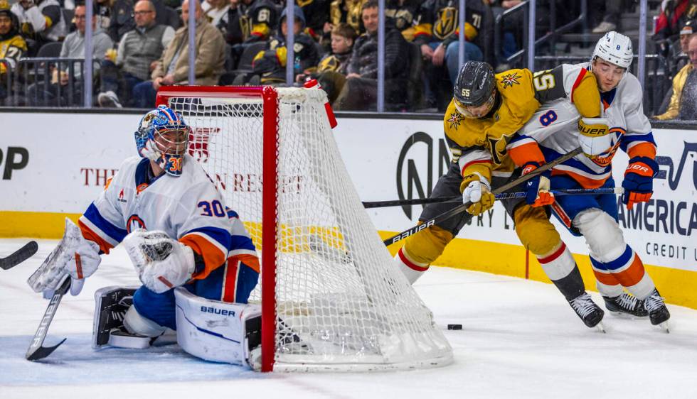 Golden Knights right wing Keegan Kolesar (55) and New York Islanders defenseman Noah Dobson (8) ...