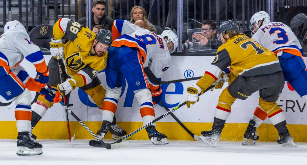 Golden Knights center Tomas Hertl (48) battles for control of the puck with New York Islanders ...