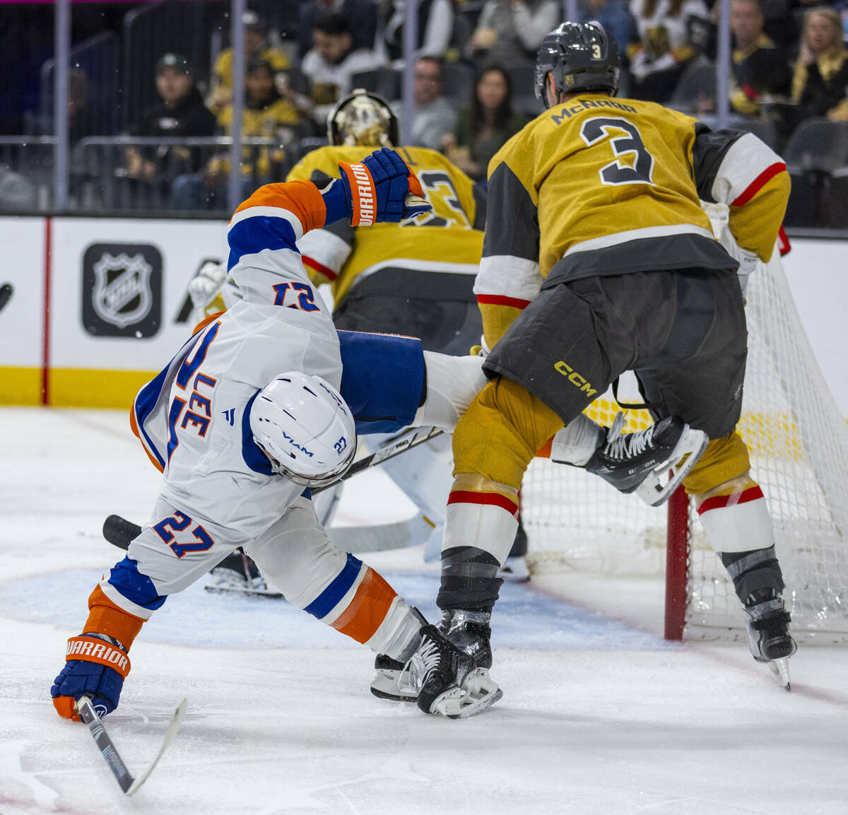 New York Islanders left wing Anders Lee (27) is tangled up with Golden Knights defenseman Brayd ...