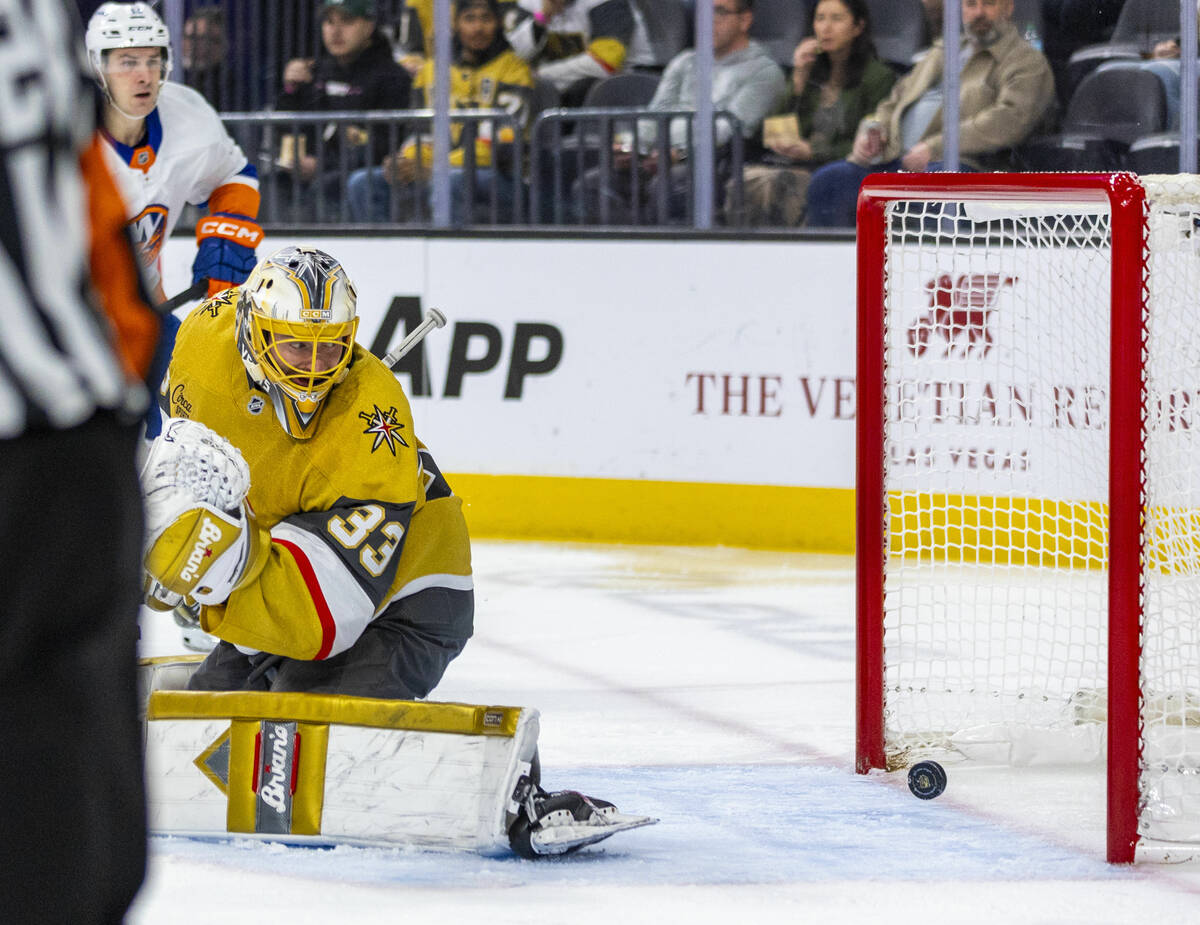 Golden Knights goaltender Adin Hill (33) watches as the puck rolls into the net against the New ...