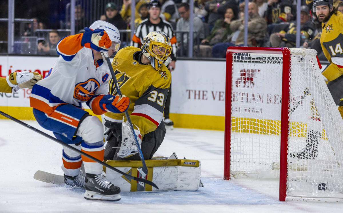 Golden Knights goaltender Adin Hill (33) watches as the puck rolls into the net against the New ...