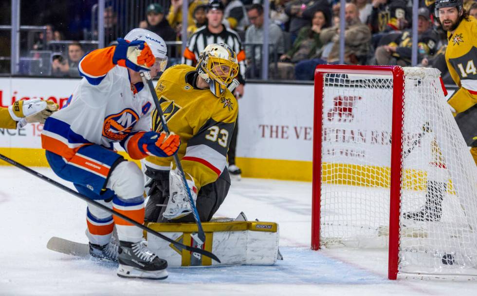 Golden Knights goaltender Adin Hill (33) watches as the puck rolls into the net against the New ...