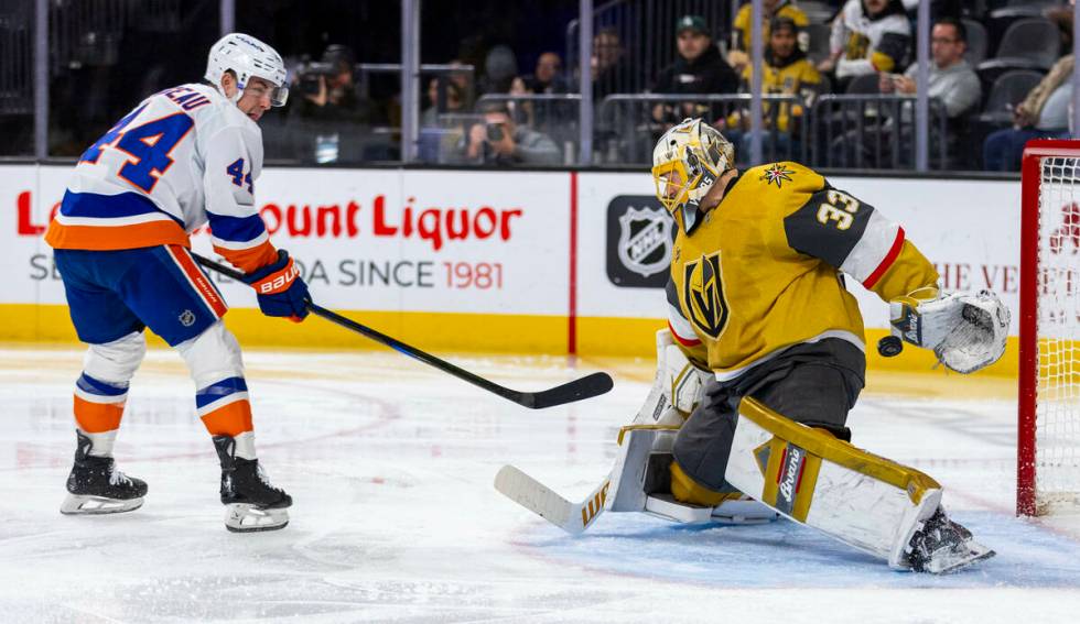 New York Islanders center Jean-Gabriel Pageau (44) slips a puck past Golden Knights goaltender ...