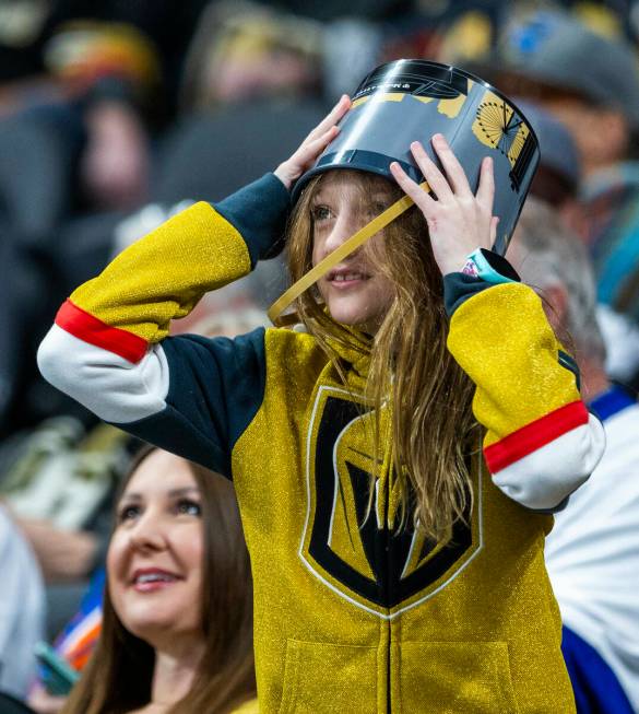 A Golden Knights fan wears a bucket on her head like a helmet at they battle the New York Islan ...