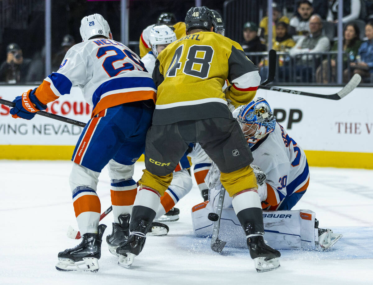 New York Islanders goaltender Ilya Sorokin (30) deflects a shot from Golden Knights center Toma ...