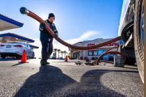 Ignacio Lopez with the Rebel Oil Company fuels up tanks at the Rebel gas station on North Buffa ...