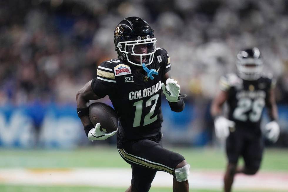 Colorado wide receiver Travis Hunter (12) runs for a touchdown against BYU after making a catch ...