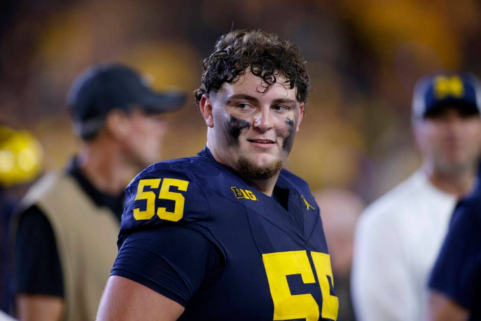 Michigan defensive lineman Mason Graham (55) walks off the field following an NCAA football gam ...