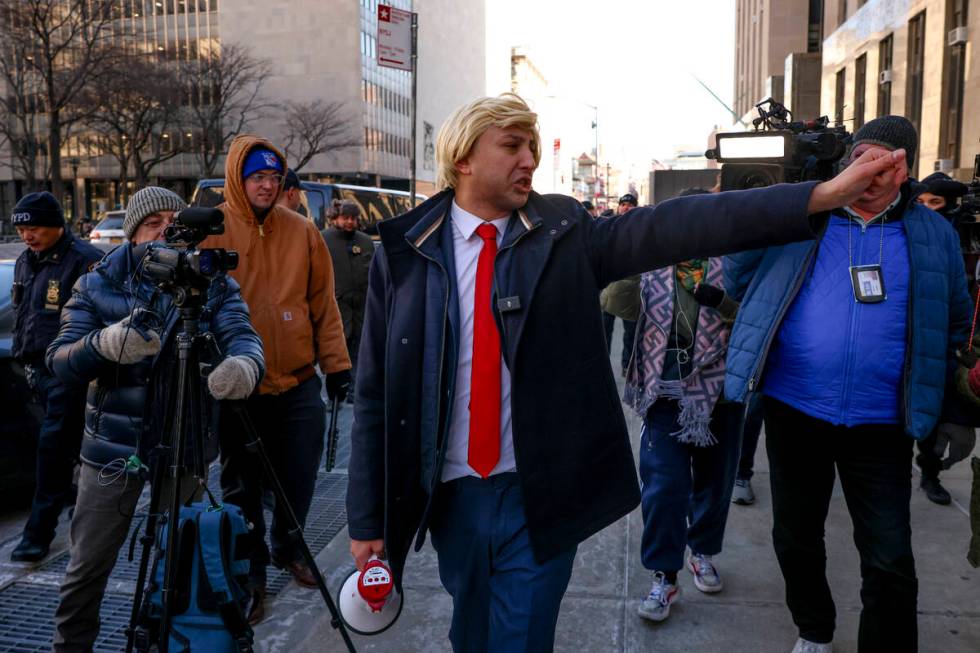 A man impersonating President-elect Donald Trump walks outside Manhattan criminal court before ...