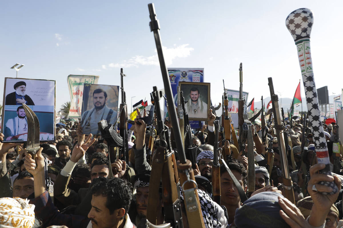 Houthi supporters raise their machine guns during an anti-Israel rally in Sanaa, Yemen, Friday, ...