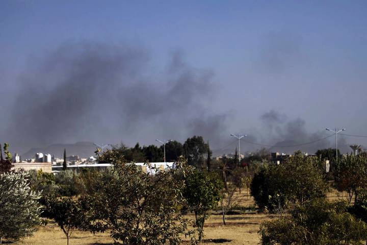 Black smoke raises following airstrikes on Sanaa, Yemen, Friday, Jan. 10, 2025. (AP Photo/Osama ...