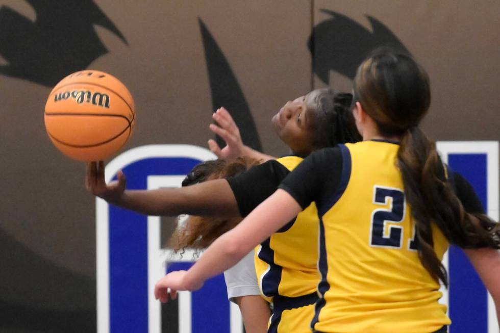 Democracy Prep's Zhanea Burrell tips a rebound back to Democracy Prep's Ella Smith during their ...