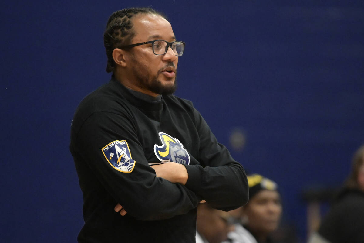 Democracy Prep head coach Julius Barren talks to his players during their NIAA basketball game ...