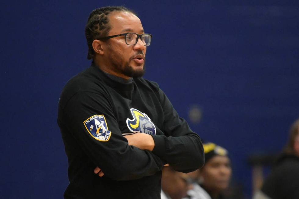 Democracy Prep head coach Julius Barren talks to his players during their NIAA basketball game ...