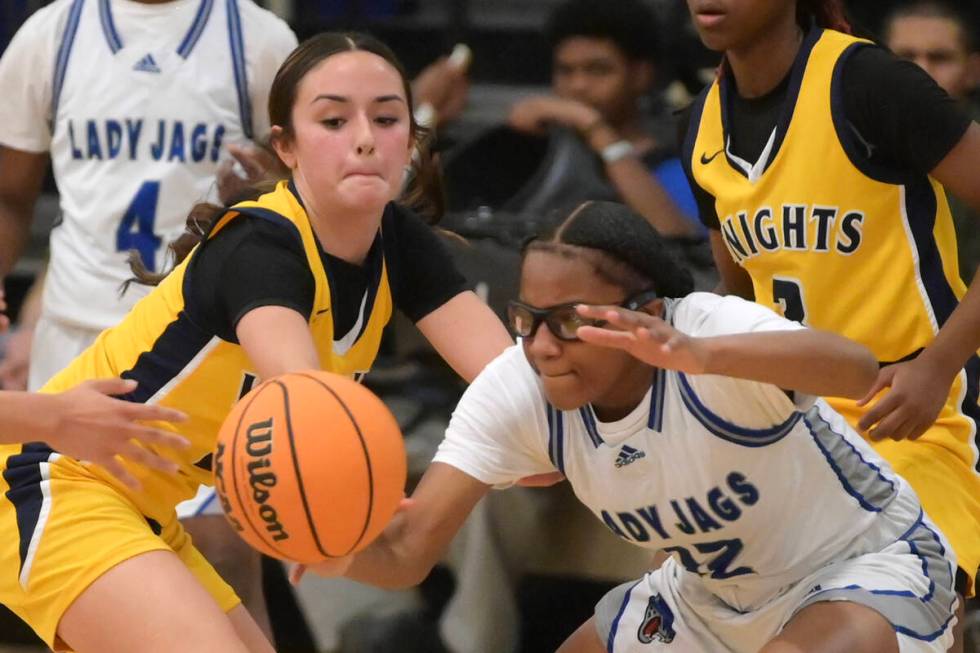 Democracy Prep's Ella Smith, left, and Desert Pines' Aaliyah Holman reach for a loose ball duri ...