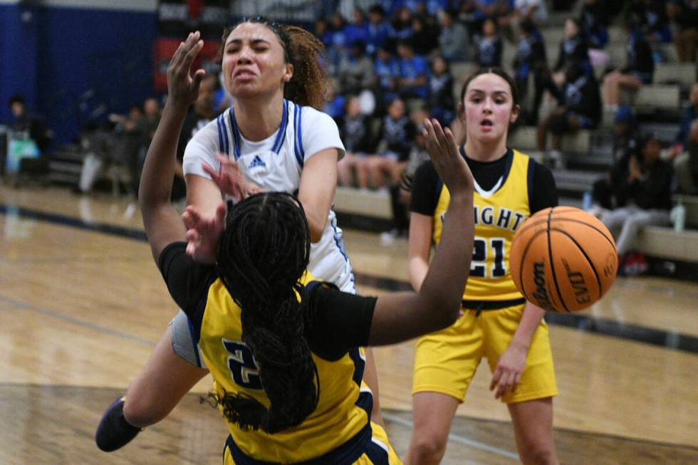 Democracy Prep's Zhanea Burrell draws a charge from Desert Pines' Mya Harper during their NIAA ...