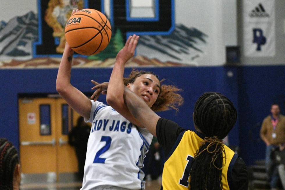 Desert Pines' Mya Harper is fouled by Democracy Prep's La’niah Hicks during their NIAA basket ...