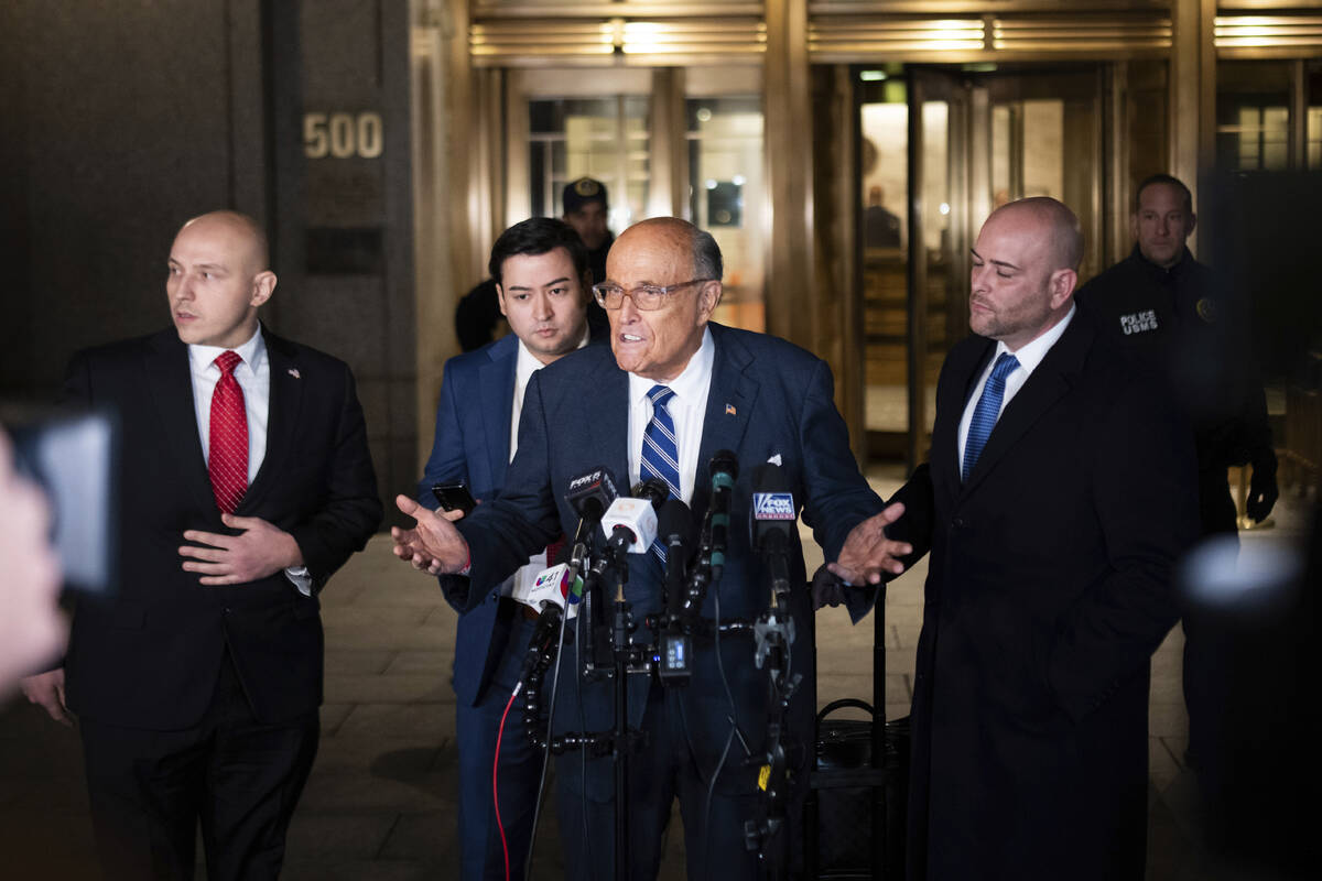 Rudy Giuliani speaks to the media outside of Manhattan federal court in New York, on Friday, Ja ...