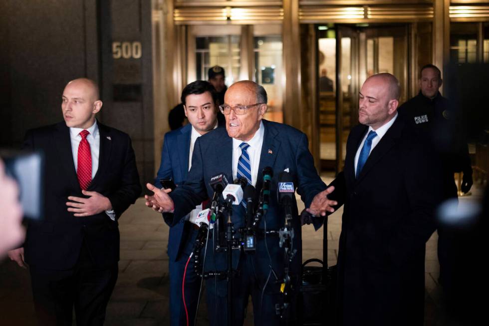 Rudy Giuliani speaks to the media outside of Manhattan federal court in New York, on Friday, Ja ...