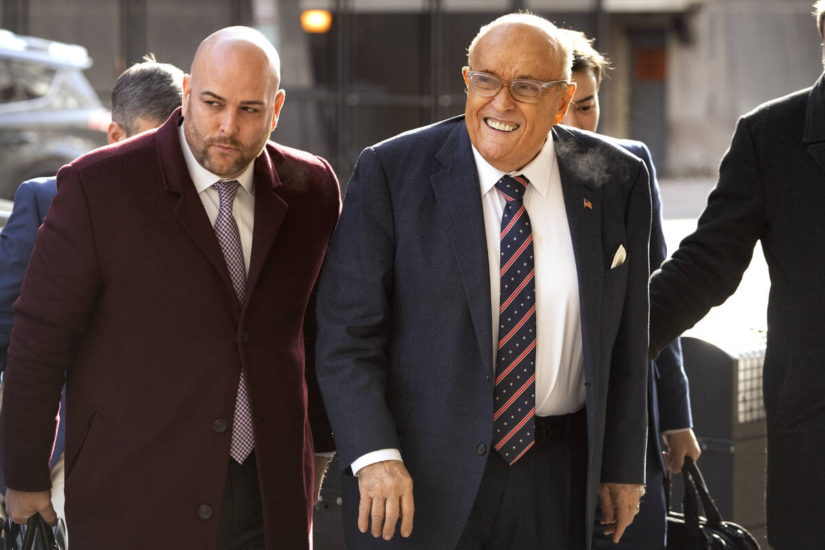 Rudy Giuliani, right, arrives at federal court in Washington, Friday, Jan. 10, 2025. (AP Photo/ ...