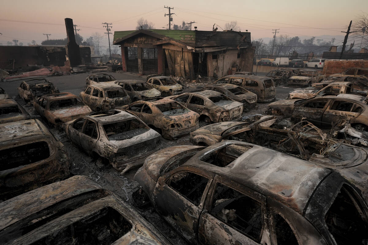 Cars are left charred inside a dealership in the aftermath of the Eaton Fire Friday, Jan. 10, 2 ...