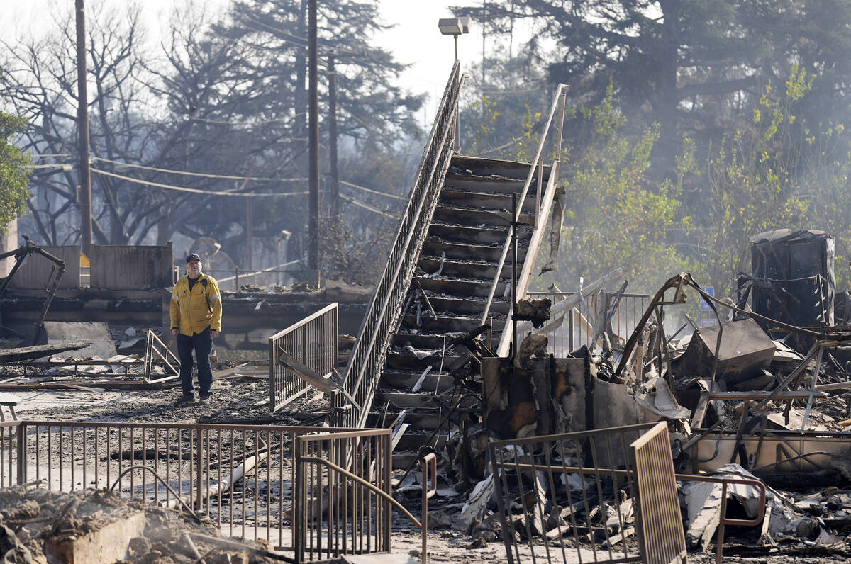 A firefighter studies the charred remains of St. Mark's School, a preschool and K-6 grade schoo ...